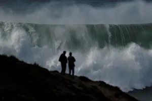 People gather to watch a tow-in surfing session at Praia do Norte in Nazare People gather to watch a tow-in surfing session at Praia do Norte in Nazare