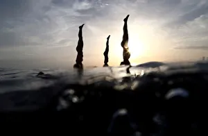 People practise standup paddleboard yoga, or SUP yoga, on the Adriatic coast in Verudela People practise standup paddleboard yoga, or SUP yoga, on the Adriatic coast in Verudela