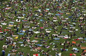 People sunbath on a field at a public swimming pool in Prague on a hot day People sunbath on a field at a public swimming pool in Prague on a hot day