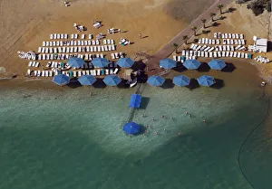 People sunbathe at a public beach in this aerial view of the Dead Sea People sunbathe at a public beach in this aerial view of the Dead Sea