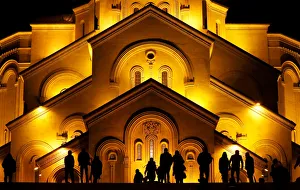 People walk in front of the Holy Trinity cathedral a midnight Christmas service in People walk in front of the Holy Trinity cathedral a midnight Christmas service in