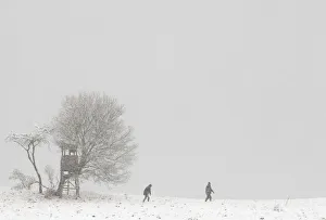 People walk through a snowy landscape near the village of Dorndorf-Steudnitz People walk through a snowy landscape near the village of Dorndorf-Steudnitz