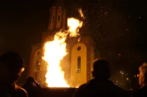 People watch burning Yule logs in front of the Church of the Holy Mother of God during People watch burning Yule logs in front of the Church of the Holy Mother of God during