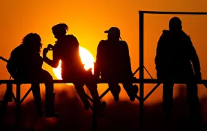 People watch the sunset on the banks of river Pripyat in the town of Turov People watch the sunset on the banks of river Pripyat in the town of Turov