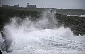People watch waves breaking on the Brittany coast as storm Eleanor approaches Esquibien