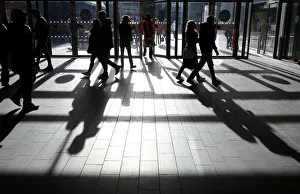 Peoples shadows are seen as shoppers are silhouetted in the bright sunshine at the Peoples shadows are seen as shoppers are silhouetted in the bright sunshine at the