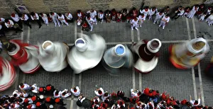 Performers dressed as traditional figures dance through the streets during the San Performers dressed as traditional figures dance through the streets during the San