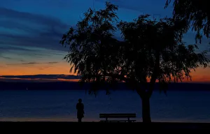 A person is seen during sunset at lake Neusiedl in Podersdorf A person is seen during sunset at lake Neusiedl in Podersdorf