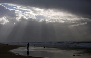 Images Dated 7th January 2013: A person stands on the shores of the Mediterranean Sea on a stormy day at Nitzanim beach