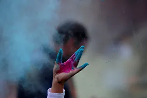 A person throws colored powder during a Holi festival party organized by Jai Jai Hooray A person throws colored powder during a Holi festival party organized by Jai Jai Hooray