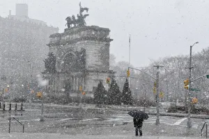 A person walks through the snow during a storm in the Brooklyn borough of New York City A person walks through the snow during a storm in the Brooklyn borough of New York City