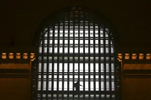 A person walks in front of a window at Grand Central Terminal in the Manhattan borough of A person walks in front of a window at Grand Central Terminal in the Manhattan borough of