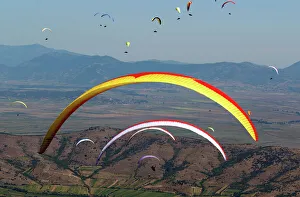 Pilots fly their paragliders during 16th FAI Paragliding World Championship in Krusevo Pilots fly their paragliders during 16th FAI Paragliding World Championship in Krusevo