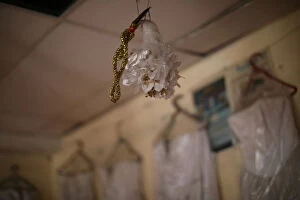 Plastic flower bouquet hangs on display for rent at a store in Port-au-Prince