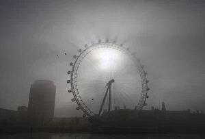 Images Dated 15th March 2012: The pods on the London Eye casts shadows against a thick morning fog as the spring