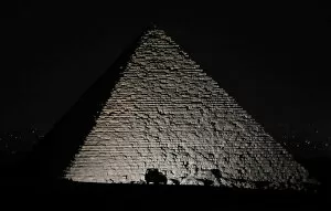 Ancient Egyptian Architecture Gallery: A police car is seen in front of the Great Pyramids in Giza, on the outskirts of Cairo