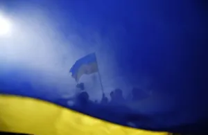 Pro-Ukrainian supporters are seen though a Ukrainian flag as they take part in a rally Pro-Ukrainian supporters are seen though a Ukrainian flag as they take part in a rally