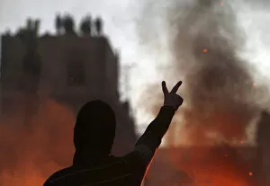 Images Dated 26th January 2013: Protester opposing Egyptian President Mursi gestures at riot police during clashes in