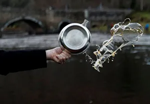 A Quaich of whisky is thrown in the river to bless the river on the opening day of the A Quaich of whisky is thrown in the river to bless the river on the opening day of the