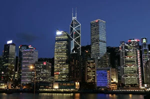 Images Dated 31st July 2007: Queens Pier is lit up in front of skyline in Hong Kongs central financial district