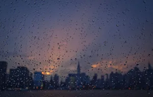 Rain is seen on a window of a ferry boat as it passes midtown Manhattan and the Empire Rain is seen on a window of a ferry boat as it passes midtown Manhattan and the Empire