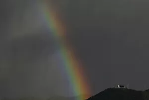 Images Dated 18th October 2013: A rainbow is seen next to Guadalupe church at sunset, after heavy rains in Bogota