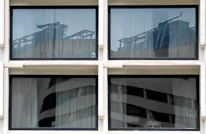 Images Dated 3rd January 2018: Reflection of construction sites is seen on glass panels of a building in Colombo