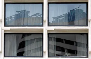 Reflection of construction sites is seen on glass panels of a building in Colombo Reflection of construction sites is seen on glass panels of a building in Colombo