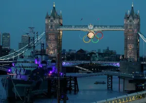Prints of The full moon rises through the Olympic Rings hanging beneath Tower Bridge, near the HMS Belfast museum warship, during the London 2012 Olympic Games August 3, 2012 Museum Prints: London 2012 Olympic Games Print