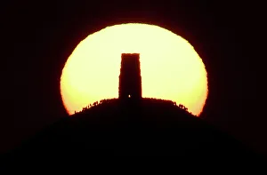 Revellers celebrate the Summer Solstice as the sun rises at Glastonbury Tor in Glastonbury Revellers celebrate the Summer Solstice as the sun rises at Glastonbury Tor in Glastonbury