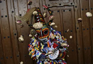 Revellers throw turnips at the Jarramplas, a character who wears a devil-like mask Revellers throw turnips at the Jarramplas, a character who wears a devil-like mask