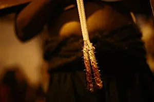 A rope with blood on it is pictured while a masked penitent flagellates himself during a A rope with blood on it is pictured while a masked penitent flagellates himself during a