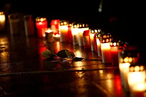 A rose is placed next to the candles at the memorial at the site of last years truck A rose is placed next to the candles at the memorial at the site of last years truck