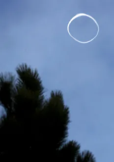 A round circle of smoke coming from the mouth of the Etna volcano is seen in the sky A round circle of smoke coming from the mouth of the Etna volcano is seen in the sky