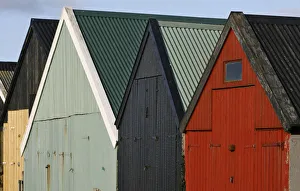 A row of brightly painted boat sheds line the harbor in the village of Famjin A row of brightly painted boat sheds line the harbor in the village of Famjin