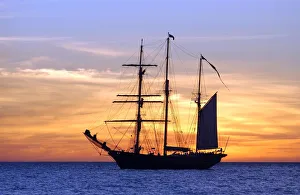 Sail training barquentine ship Leeuwin sails in the Indian Ocean at sunset off the Sail training barquentine ship Leeuwin sails in the Indian Ocean at sunset off the