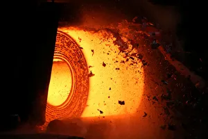 Scale flies off of a steel coil as it is unrolled on the line at the Novolipetsk Steel Scale flies off of a steel coil as it is unrolled on the line at the Novolipetsk Steel