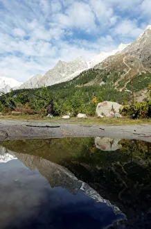 A segment of the Planpincieux glacier is reflected in water on the Italian side of the A segment of the Planpincieux glacier is reflected in water on the Italian side of the