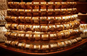 Sets of gold bangles are displayed in a showcase of a showroom selling bridal jewellery Sets of gold bangles are displayed in a showcase of a showroom selling bridal jewellery