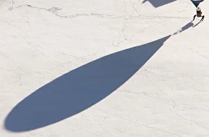 The shadow of a balloon is cast on the snow covered ground as it just landed during The shadow of a balloon is cast on the snow covered ground as it just landed during
