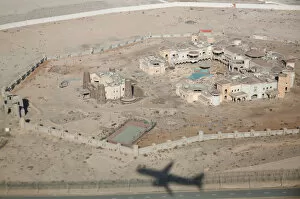 Shadow of Etihad Airways plane is seen at old buildings near Abu Dhabi International