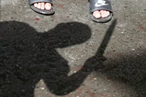 Shadow of a Shi'ite Muslim man is seen as he flagellates himself during a religious
