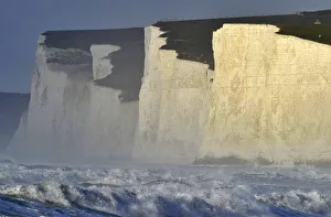 Sheep graze along the top of the Seven Sisters cliffs as heavy seas are seen in the Sheep graze along the top of the Seven Sisters cliffs as heavy seas are seen in the