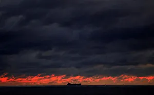 A ship sails towards Colombo main harbour as the rainy clouds gathered above the sunset A ship sails towards Colombo main harbour as the rainy clouds gathered above the sunset