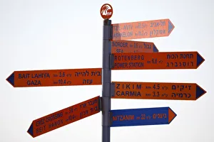 A sign displays distances to various cities and sites in Israel and the Gaza Strip A sign displays distances to various cities and sites in Israel and the Gaza Strip