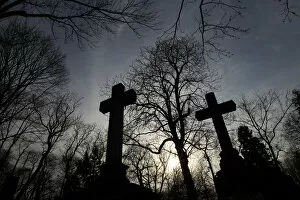 Silhouetted crosses are seen at Powazki cemetery in Warsaw