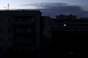 Single light illuminates a room during a blackout at a residential building in Single light illuminates a room during a blackout at a residential building in