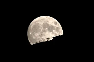A ski lift at the Kalavrita ski centre on Mount Helmos is silhouetted as the moon rises A ski lift at the Kalavrita ski centre on Mount Helmos is silhouetted as the moon rises