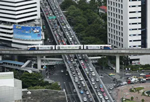 A skytrain passes over vehicles on the road during rush hour in Bangkok A skytrain passes over vehicles on the road during rush hour in Bangkok