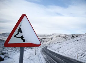 A slippery road warning sign is covered in snow on the A93 in Perthshire, Scotland A slippery road warning sign is covered in snow on the A93 in Perthshire, Scotland